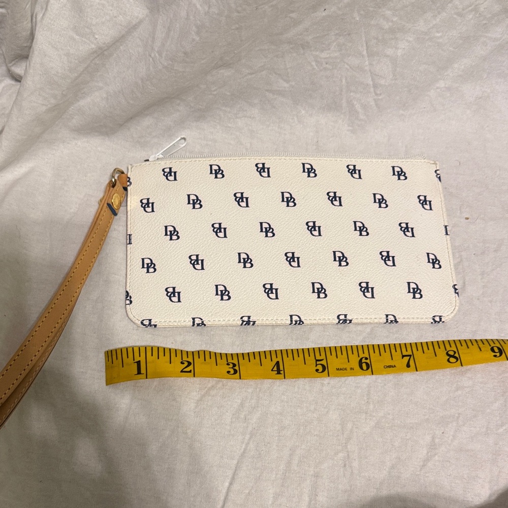 Dooney & Bourke White Wristlet with Navy Logo Print and Tan Strap